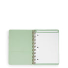 A mint green spiral-bound notebook with lined pages, shown open against a plain white background.