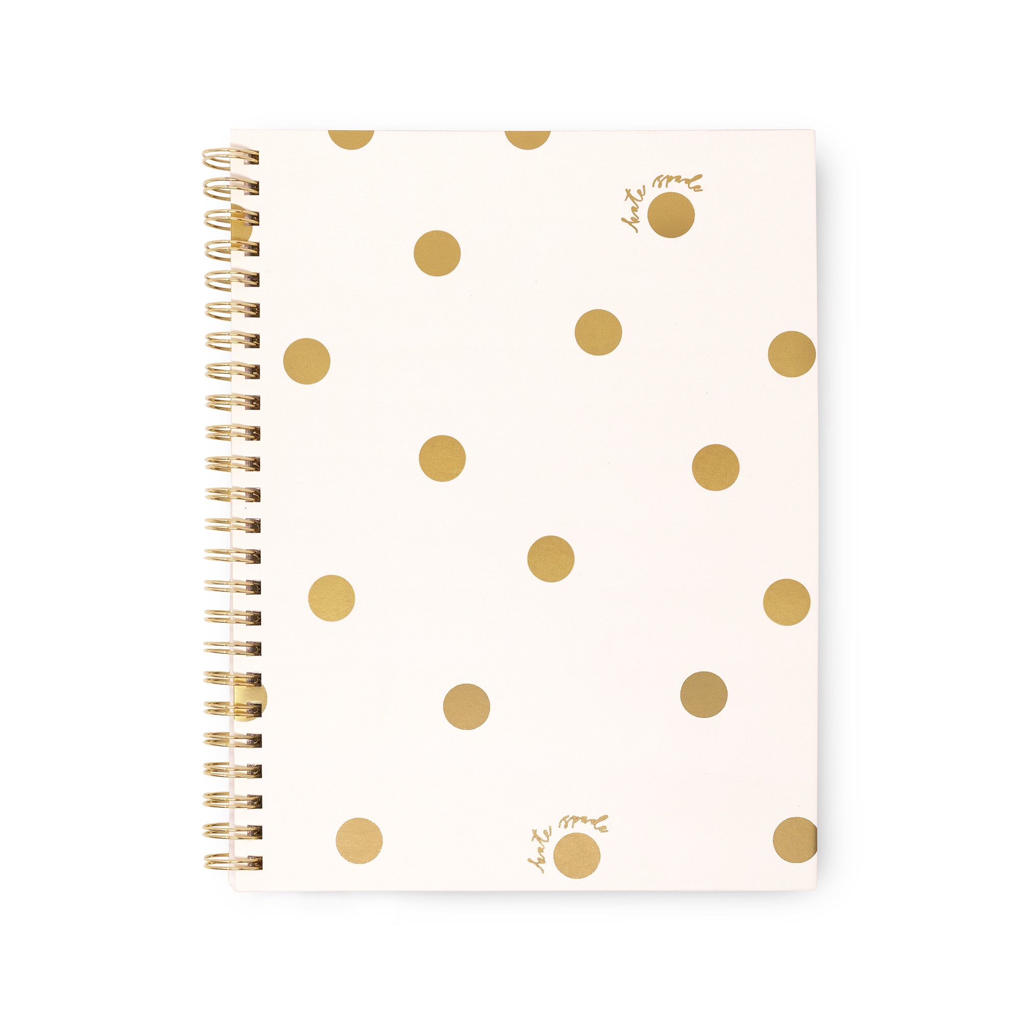 A spiral-bound notebook with a cream-colored cover decorated with scattered gold polka dots and small gold script initials, shown on a plain white background.