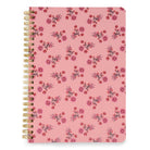 A pink spiral notebook with a repeating watercolor floral pattern in shades of red and purple, bound with gold wire on a white background.