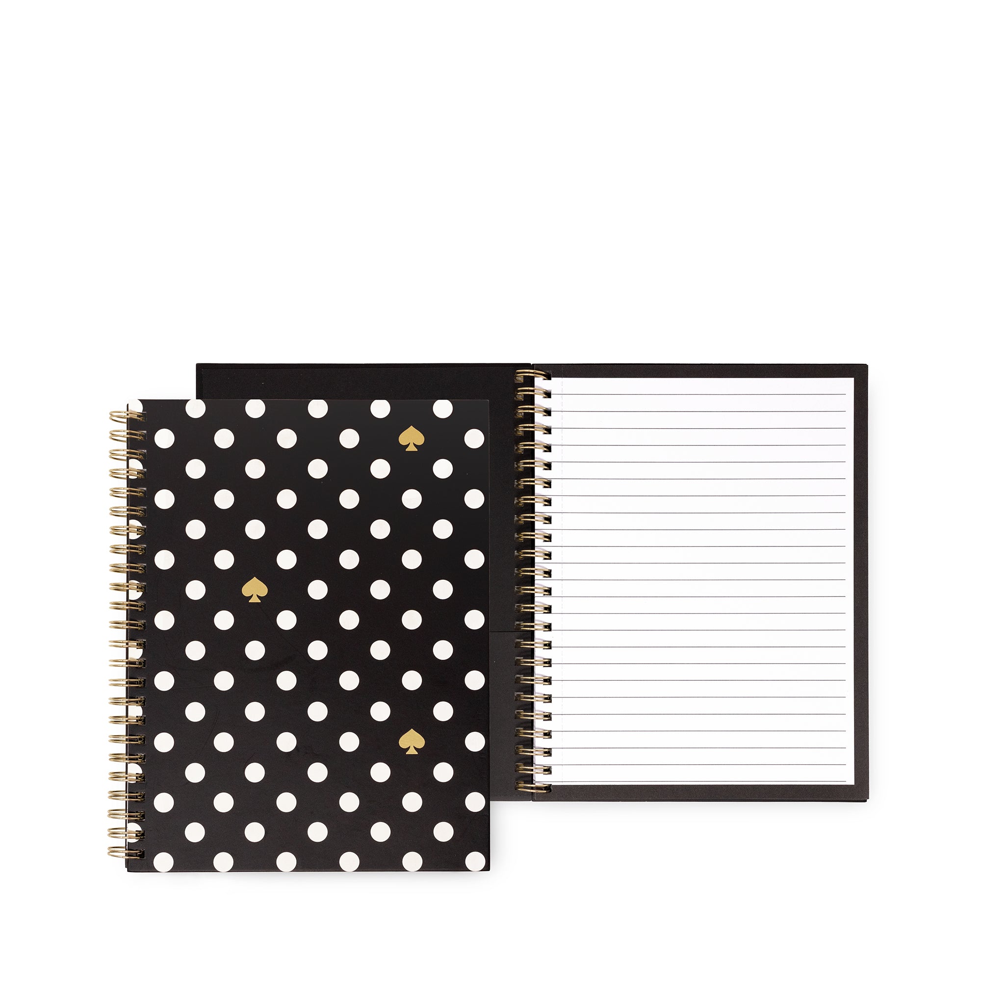 A black spiral notebook with white polka dots and small gold spade motifs on the cover, shown next to an open lined notebook page on a white background.