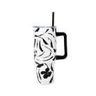 Black and white floral-patterned tumbler with a handle on a white background