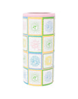 Cylindrical container with colorful patchwork design on a white background