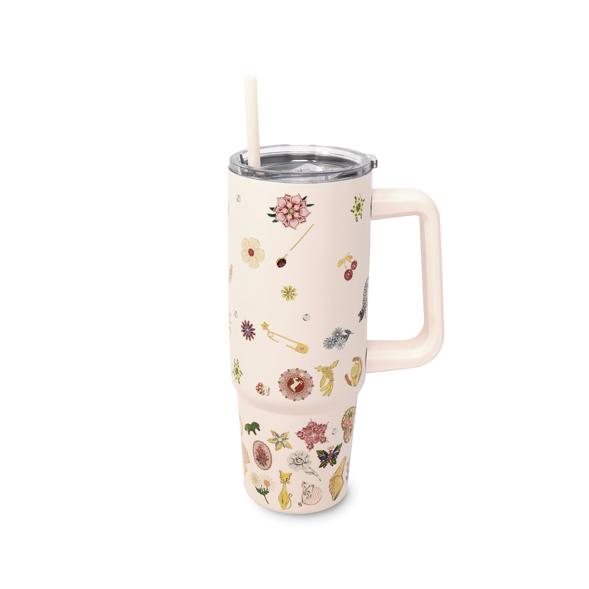 A cream-colored insulated travel tumbler with a floral and whimsical pattern, featuring a matching cream handle and a clear lid with a white straw, shown on a plain white background.