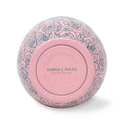 Decorative pink object with floral patterns and 'Sarah J. Maas' branding on a white background