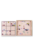 Wooden puzzle with numbered and lettered tiles on a white background