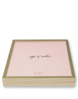 Pink game with gold trim and 'kate spade' branding on a white background