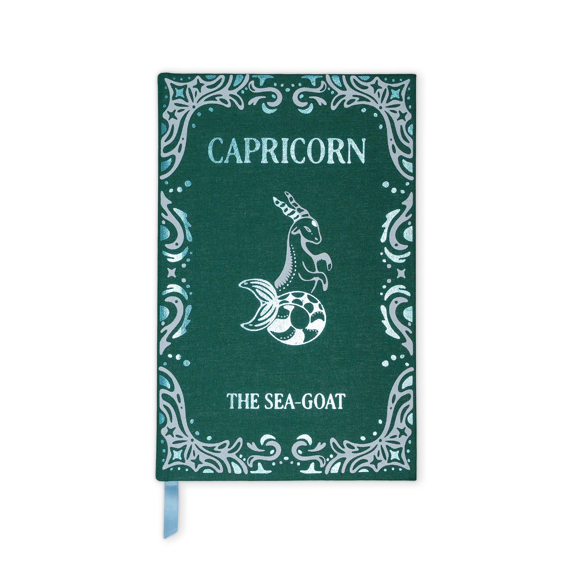 A dark green hardcover notebook or journal featuring a silver-toned Capricorn mermaid illustration and decorative border, with a light blue ribbon bookmark hanging from the bottom.