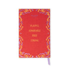 Kate Spade New York 'Playful Admirable Free Strong' notebook with a textured red cover, ornate gold, purple, and orange scrollwork border, and a lavender ribbon bookmark, shown on a white background.