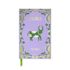 A purple Taurus zodiac-themed notebook with a green bull illustration, gold decorative border, and a green ribbon bookmark, shown on a white background.