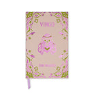 A pink notebook with a decorative foil border and a central glittery Virgo illustration. The cover features the text 'VIRGO' at the top and 'THE MAIDEN' at the bottom, with a lavender ribbon bookmark hanging from the bottom edge.