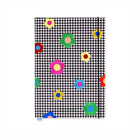 Notebook with black and white checkered pattern and colorful flowers on a white background