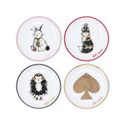 Four round white plates arranged in a 2x2 grid on a white background, each with a different illustrated character and border color: a white rabbit with a pink rim, a brown fox with a red rim, a hedgehog with a black rim, and a large gold spade symbol with a gold rim. The name 'Kate Spade' appears in script near each plate.