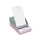Striped to-do list pad with pink holder on a white background