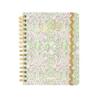 A spiral-bound planner with a light green and lavender paisley pattern, featuring gold foil script on the cover and a gold glittery wavy trim along the right edge.