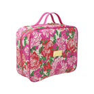 A rectangular cosmetic bag with a vibrant pink, red, and green floral print on a cream background, featuring pink handles and a gold-tone brand plaque.