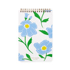Notebook with blue floral design on a white background, featuring the Kate Spade New York brand.
