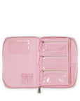 Pink travel organizer with clear compartments on a white background