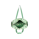 A green and white patterned duffel bag shown from a top-down view, with its interior and shoulder straps visible against a plain white background.