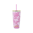 Pink floral-patterned tumbler with straw on a white background
