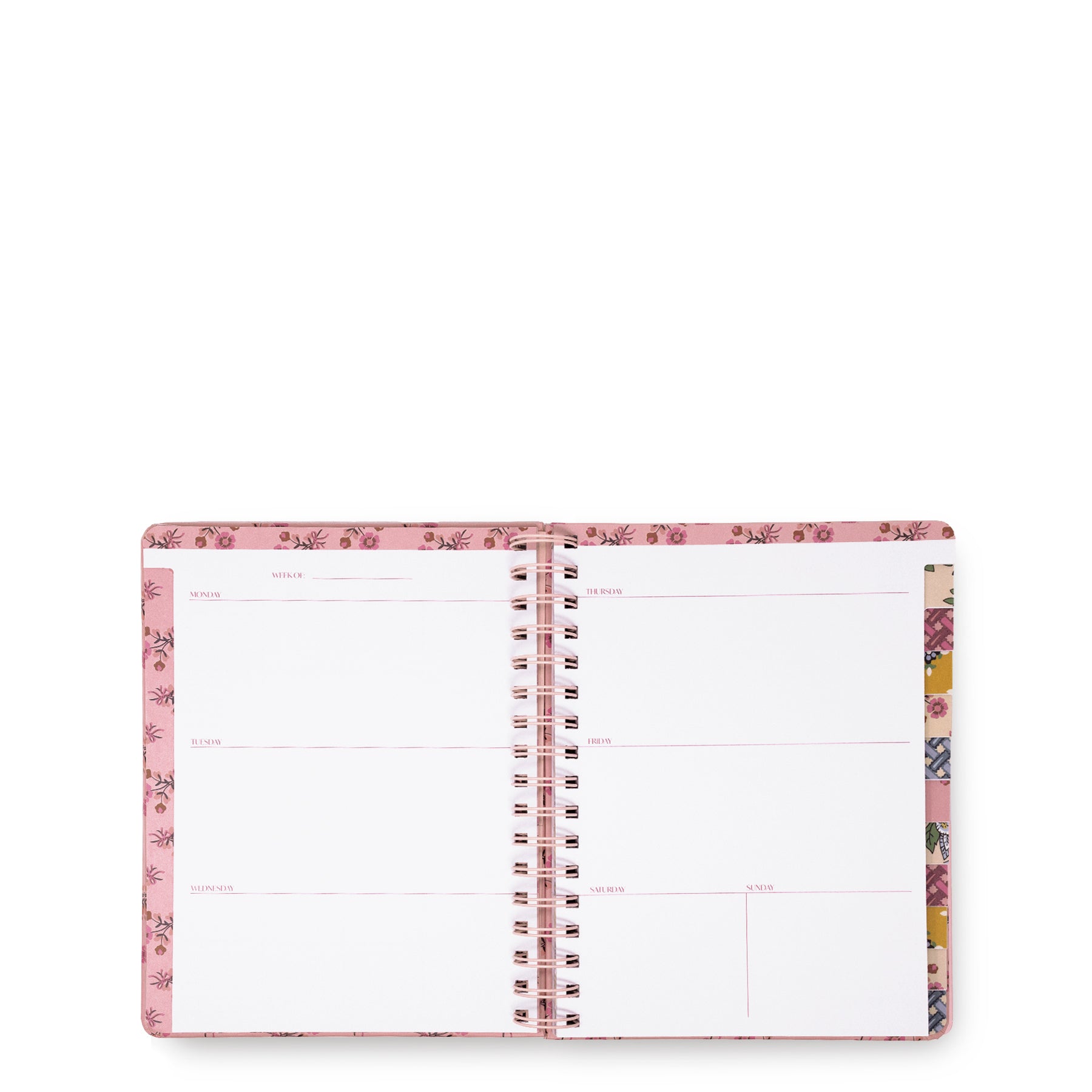An open spiral-bound planner with a pink floral patterned cover and blank white pages, photographed on a plain white background.
