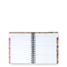 An open spiral-bound planner or weekly organizer notebook with a floral patterned cover and blank white pages, photographed on a plain white background.