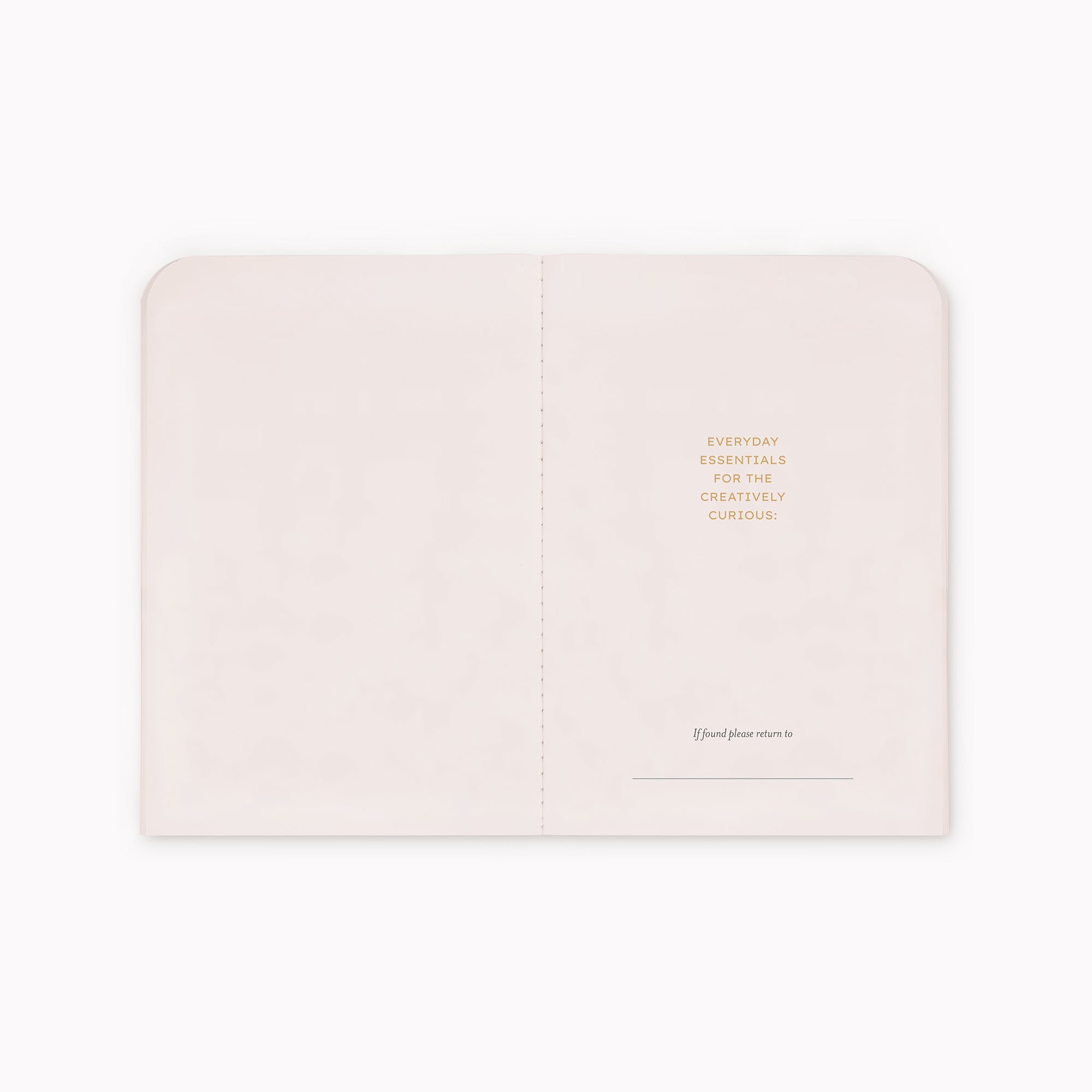 A black journal shown open flat against a white background, with small gold text on the right page and a faint brand mark near the bottom.