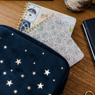 Notebook with star patterned pouch on a wooden surface