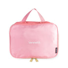 Pink travel bag with 'wear' text on a white background