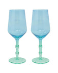 Two blue wine glasses with green stems on a white background