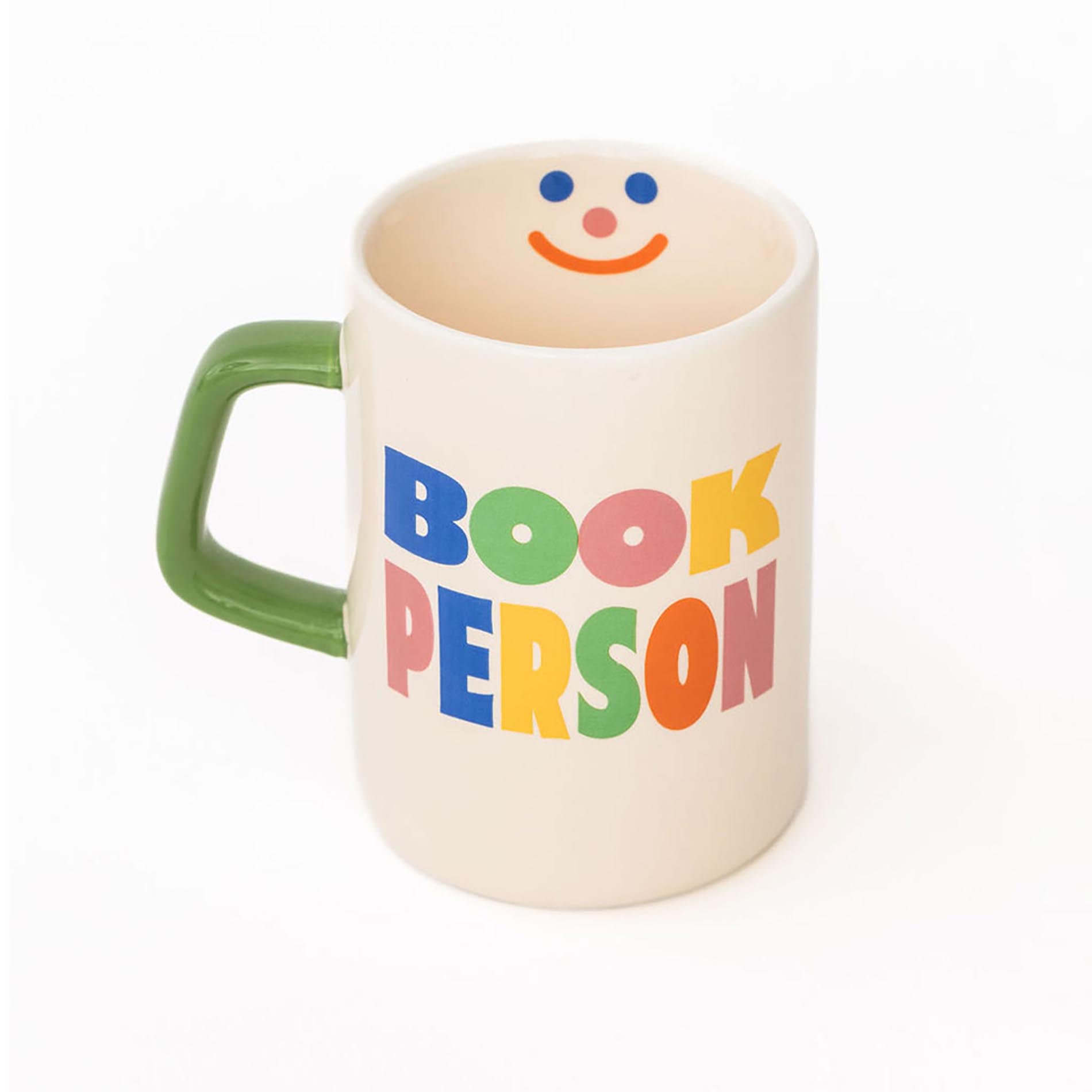 Mug with a smiley face and colorful text on a white background