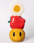 Ceramic stacked vase with white daisy, apple, and yellow smiley