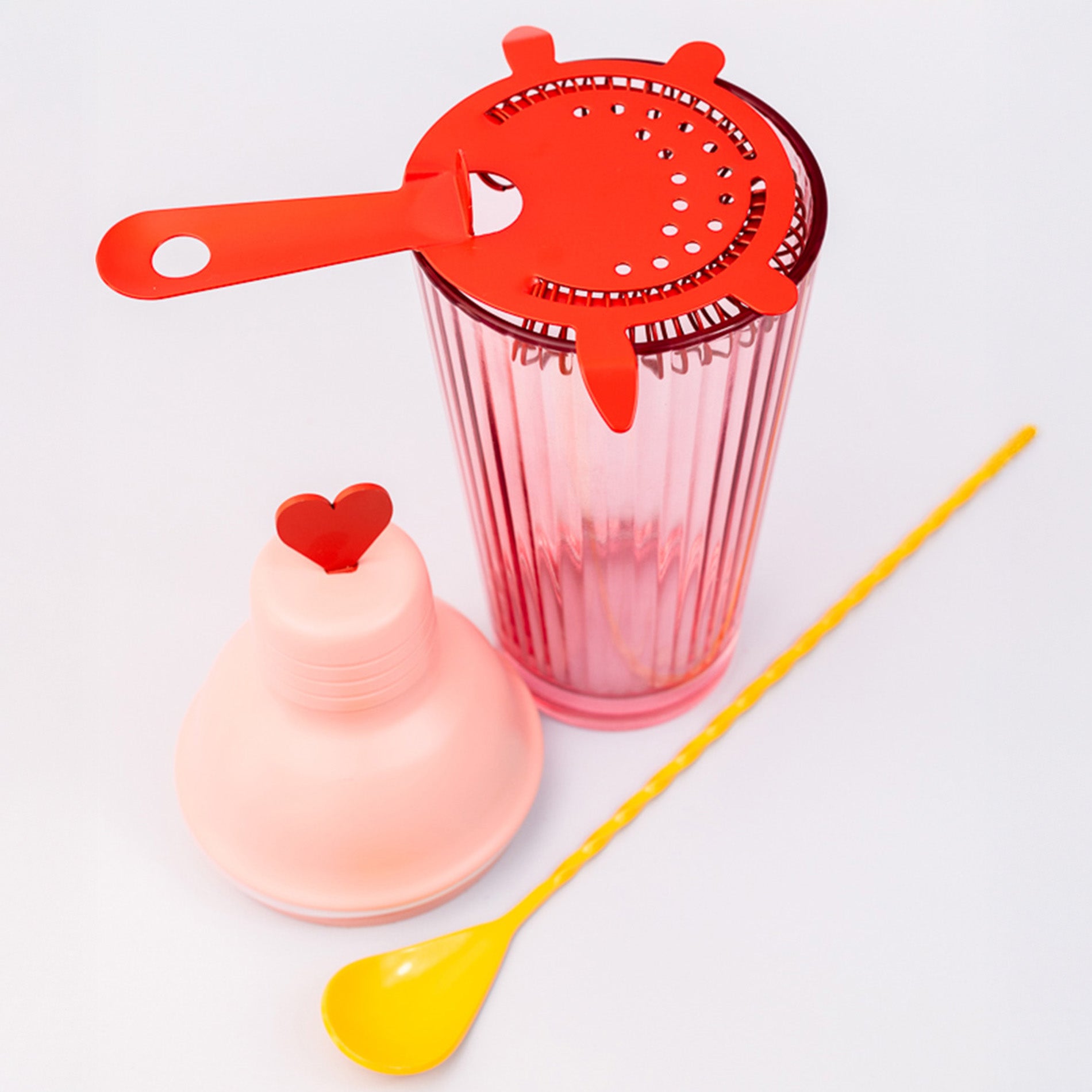 Bar set with pink shaker, red strainer and yellow heart stir spoon
