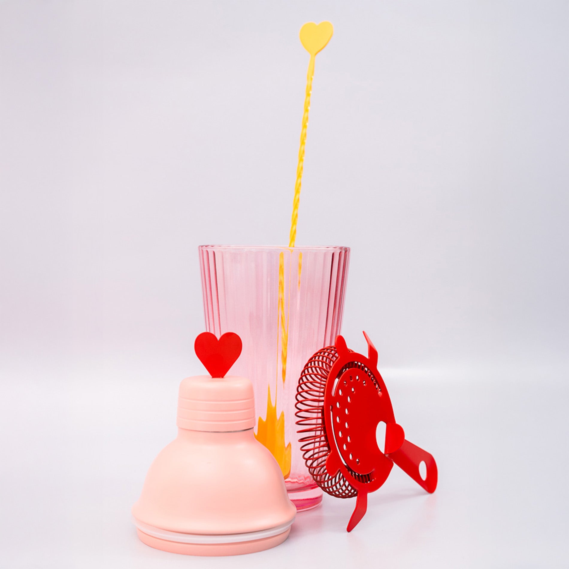 Bar set with pink shaker, red strainer and yellow heart stir spoon