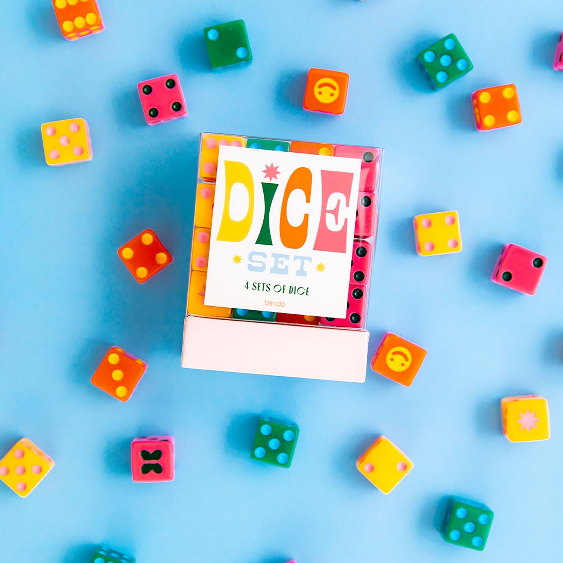 Dice set packaging with colorful dice around on a blue background