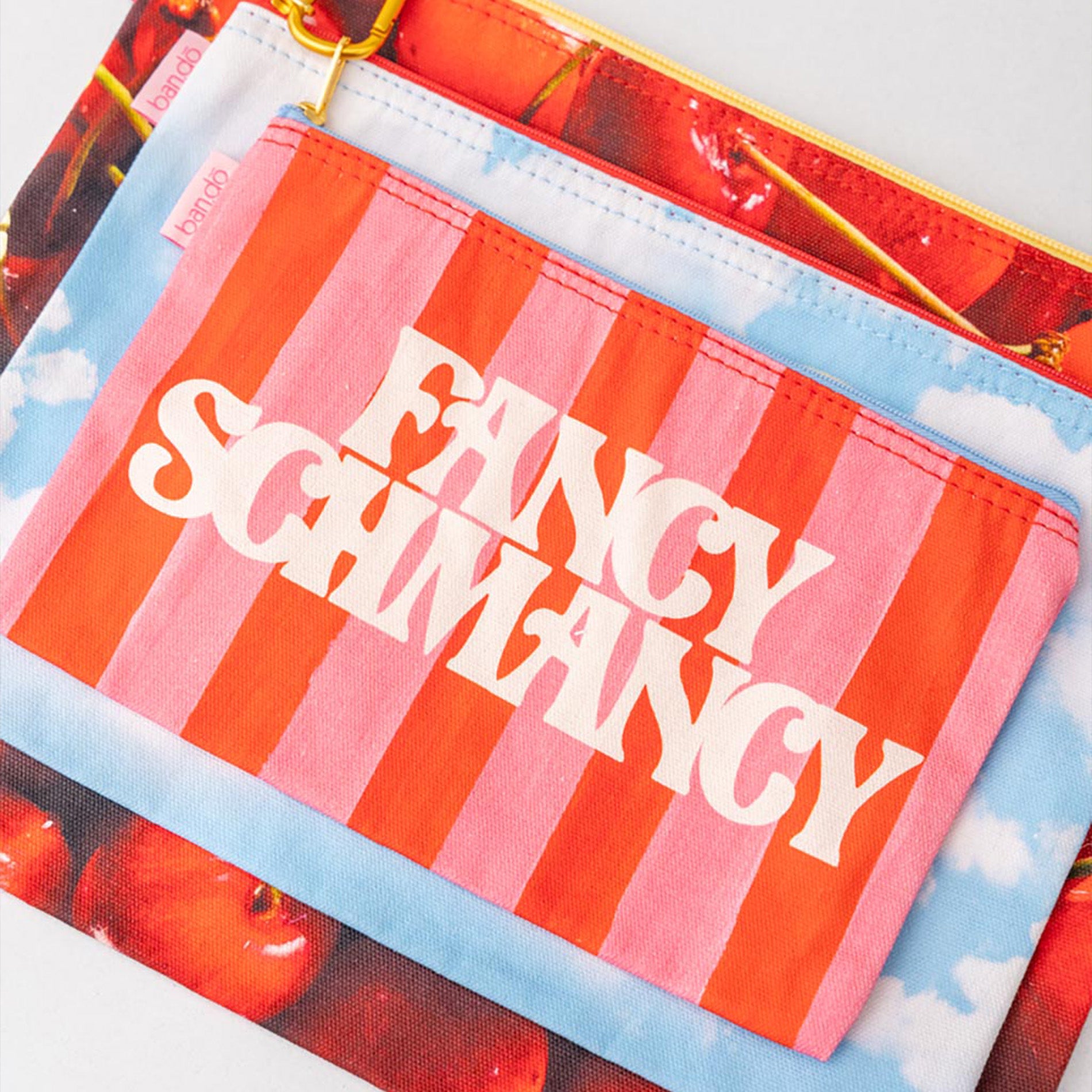 Striped pouch with 'Fancy Schnafancy' text on a colorful background