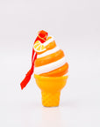 Decorative ice cream cone ornament with orange and white swirls on a white background