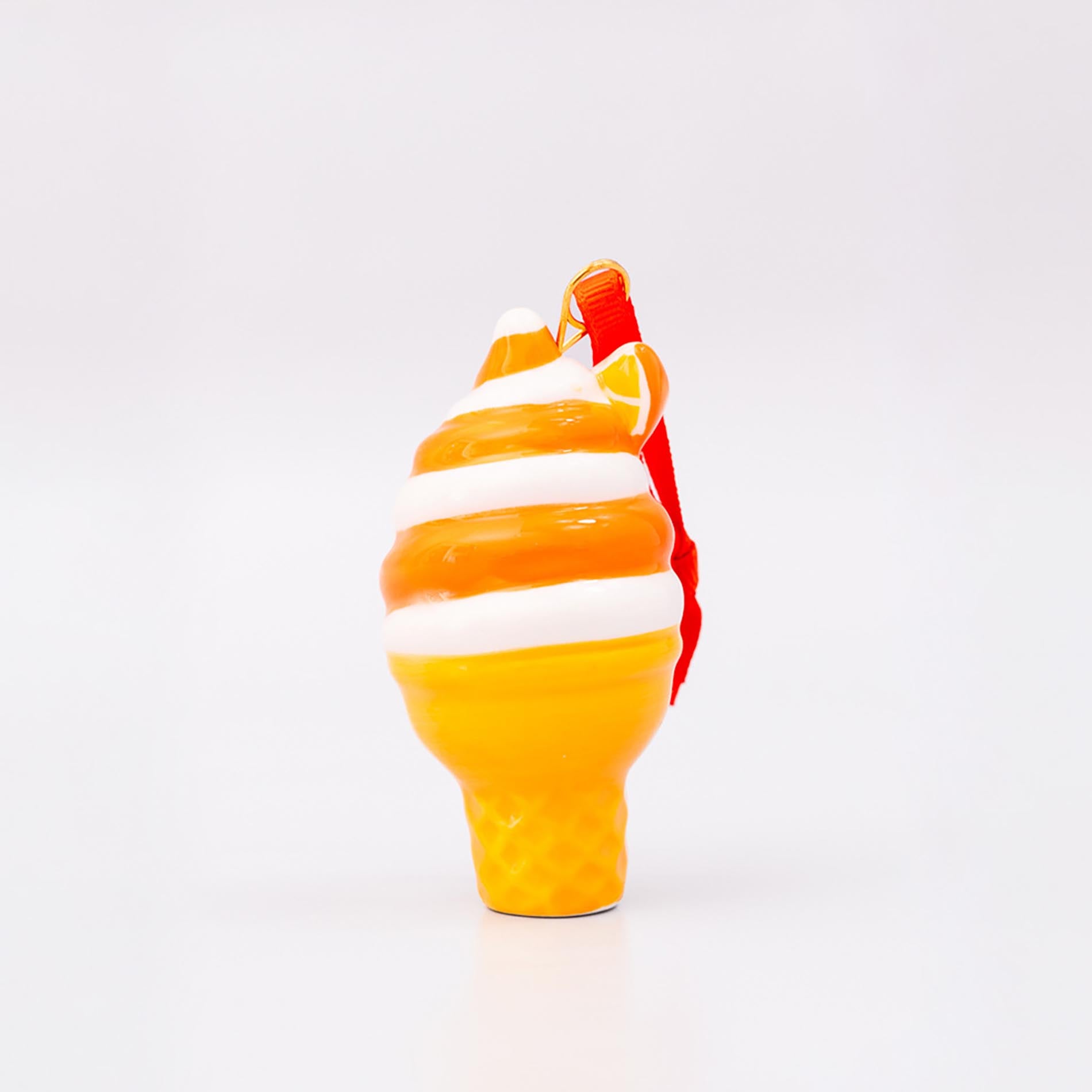 Glass sculpture of a candy corn design on a white background