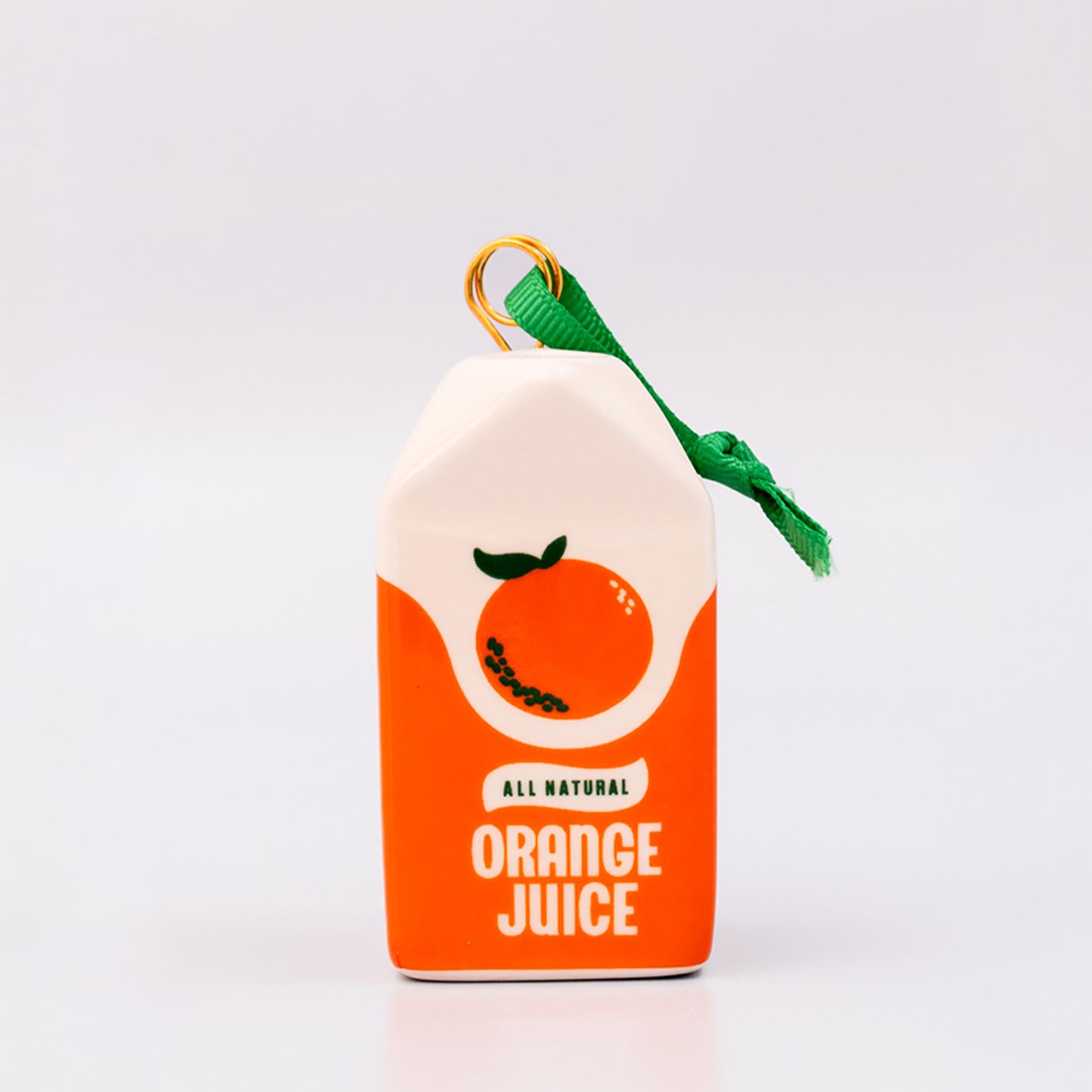 Sideview of ceramic orange juice carton ornament