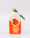 Sideview of ceramic orange juice carton ornament