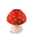 Mushroom-shaped vase with red cap and white polka dots on a beige stem against a white background