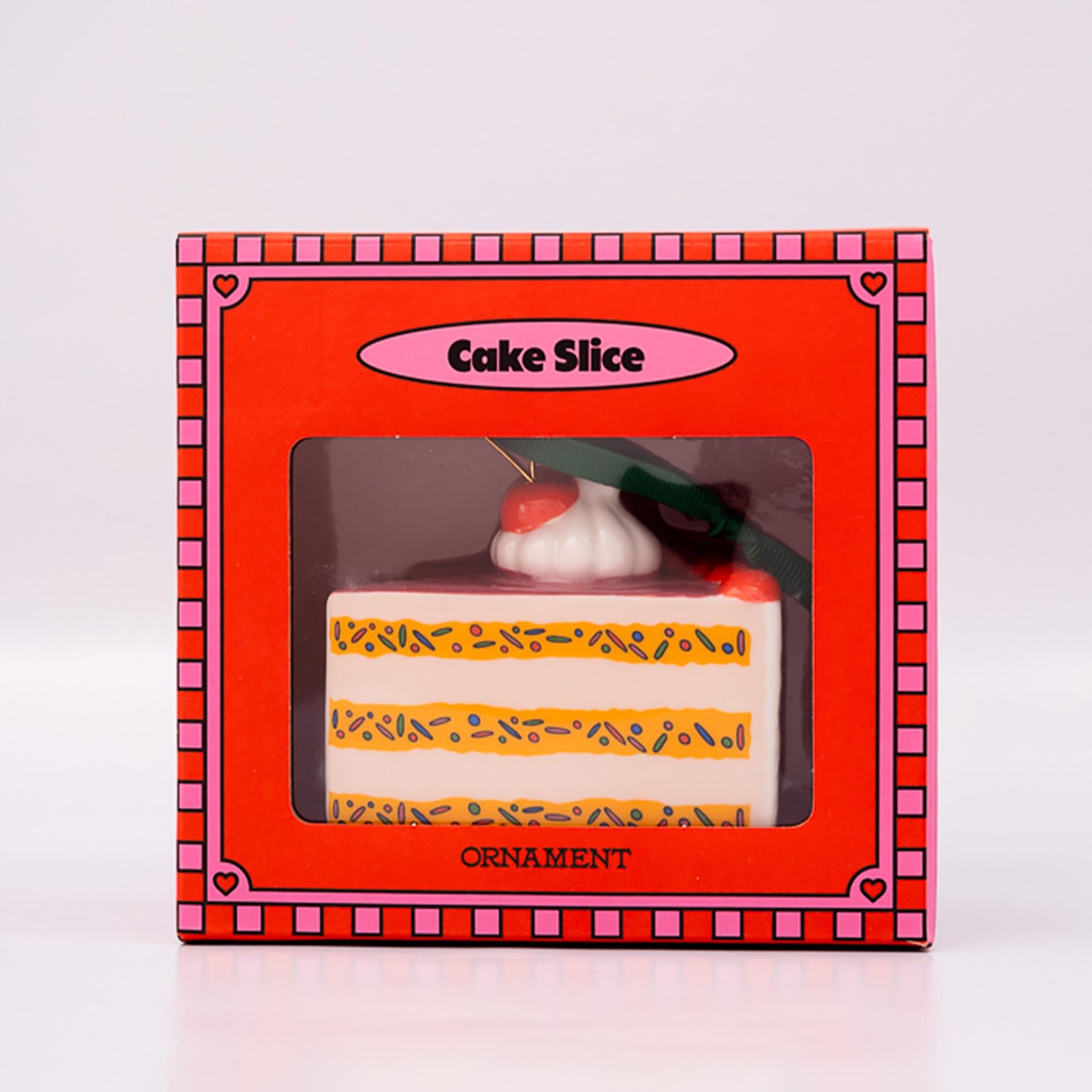 Cake slice ornament in a decorative box on a white background