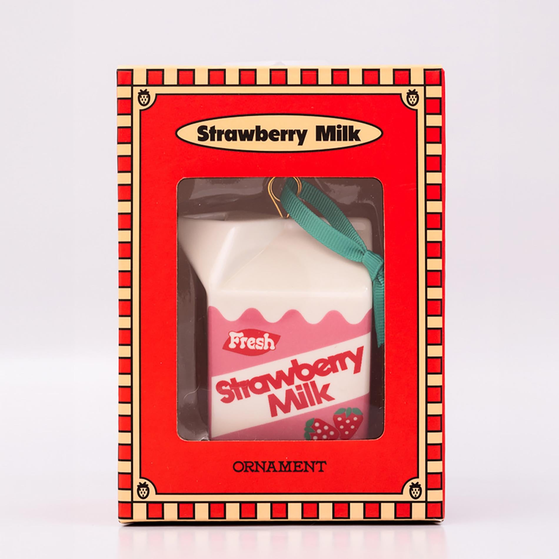 Packaged strawberry milk carton-shaped ornament on a white background