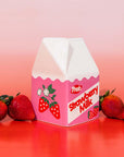 Pink strawberry milk carton with strawberries on a gradient background