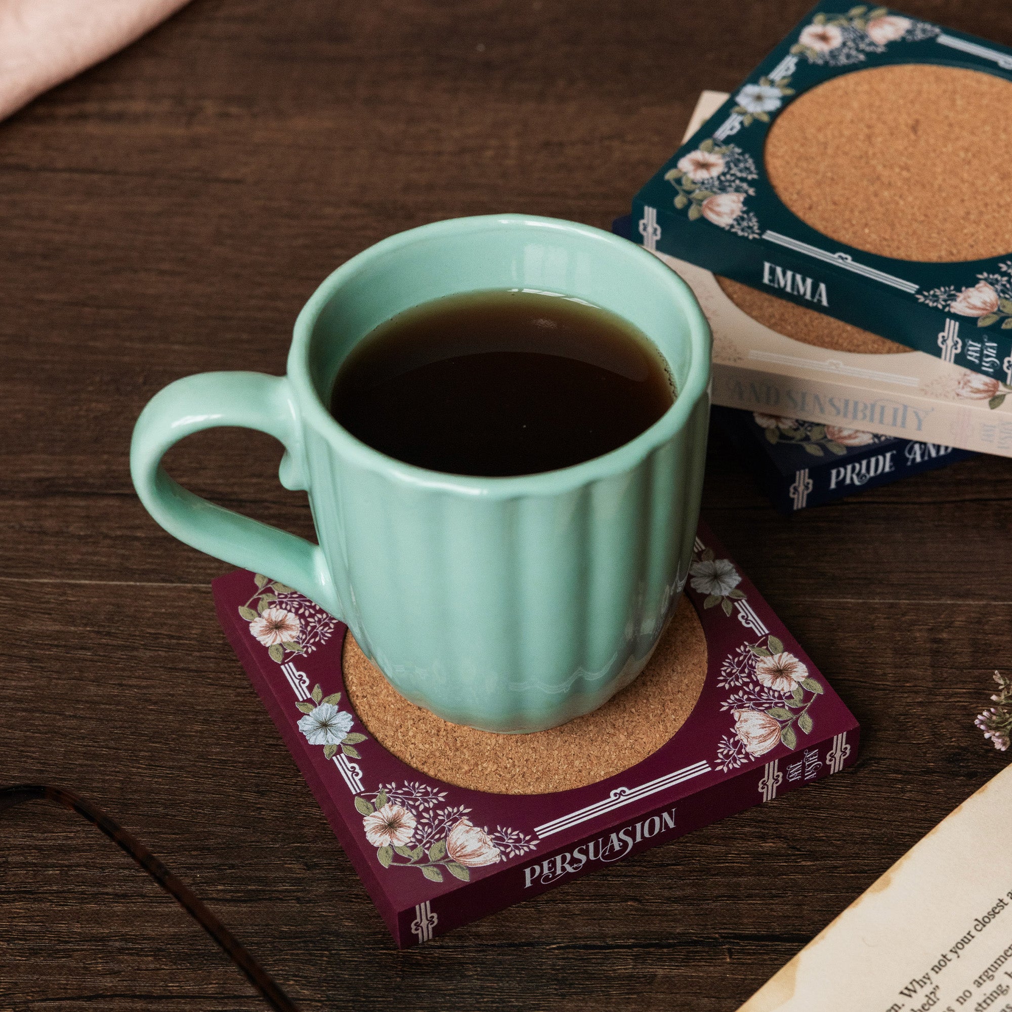 Floral-patterned coasters with jane austen book titles on the side