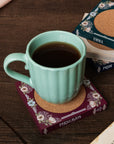 Floral-patterned coasters with jane austen book titles on the side