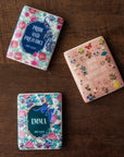 Three book-themed magnets with floral designs and book titles on a white background