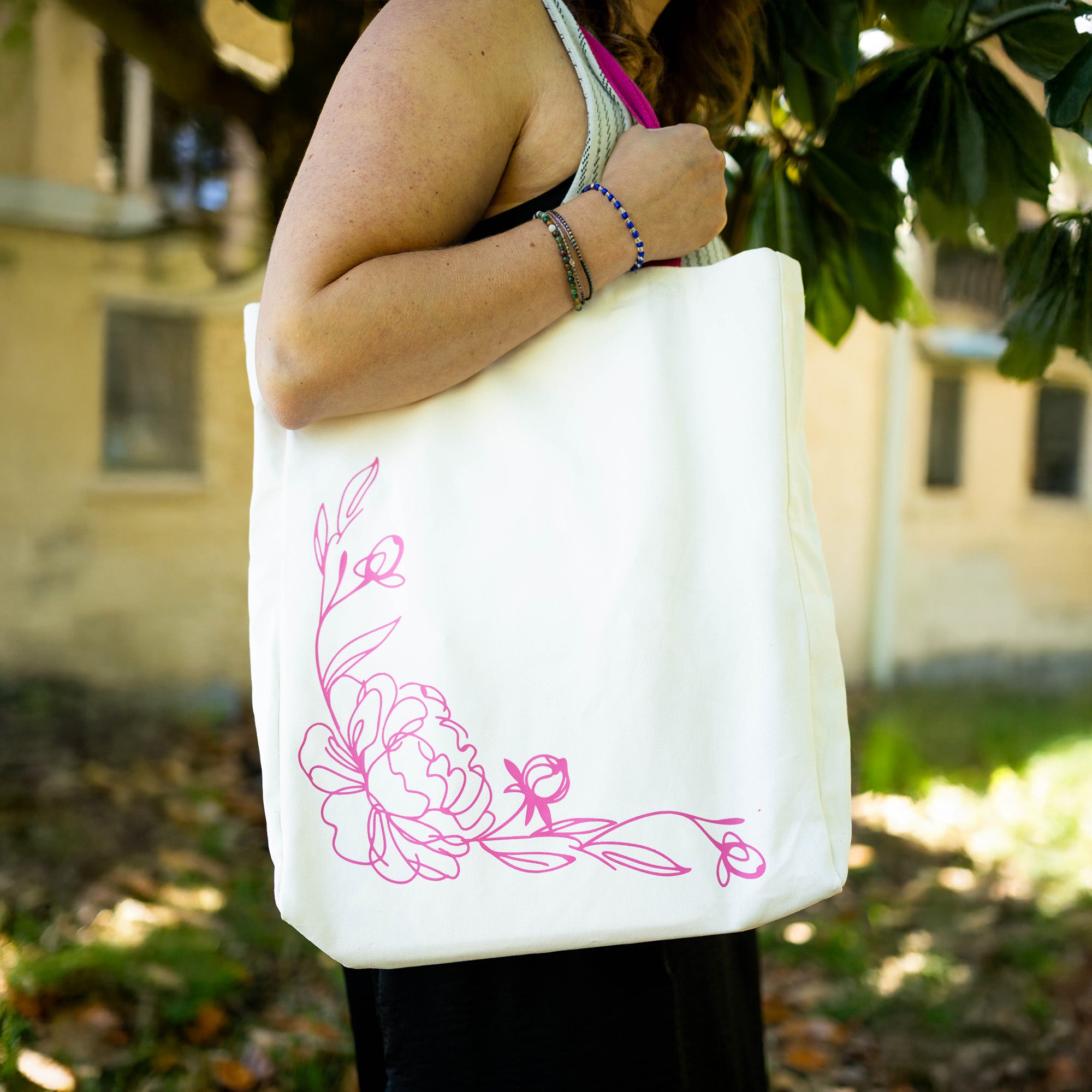 reversed floral sketch of white tote with pink strap and lettering that says 'I love you...thorns and all' with a sketched floral print