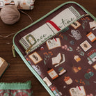 brown book sleeve with colorful cozy book nook icons