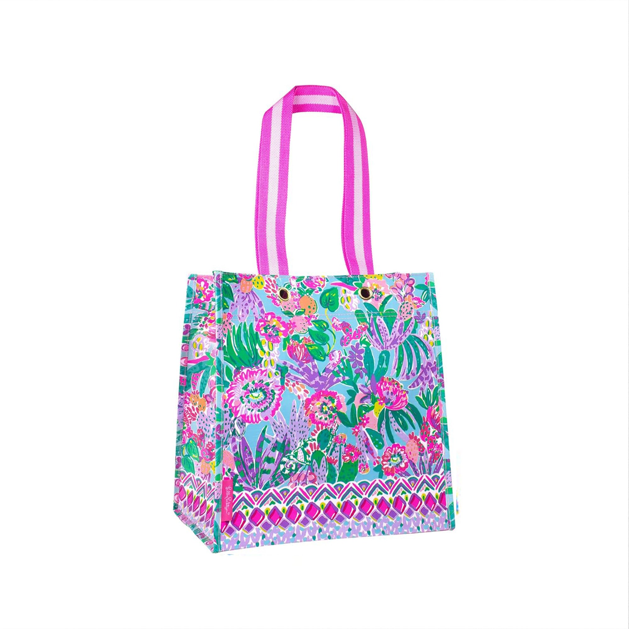 Colorful floral-patterned tote bag with pink handles on a white background