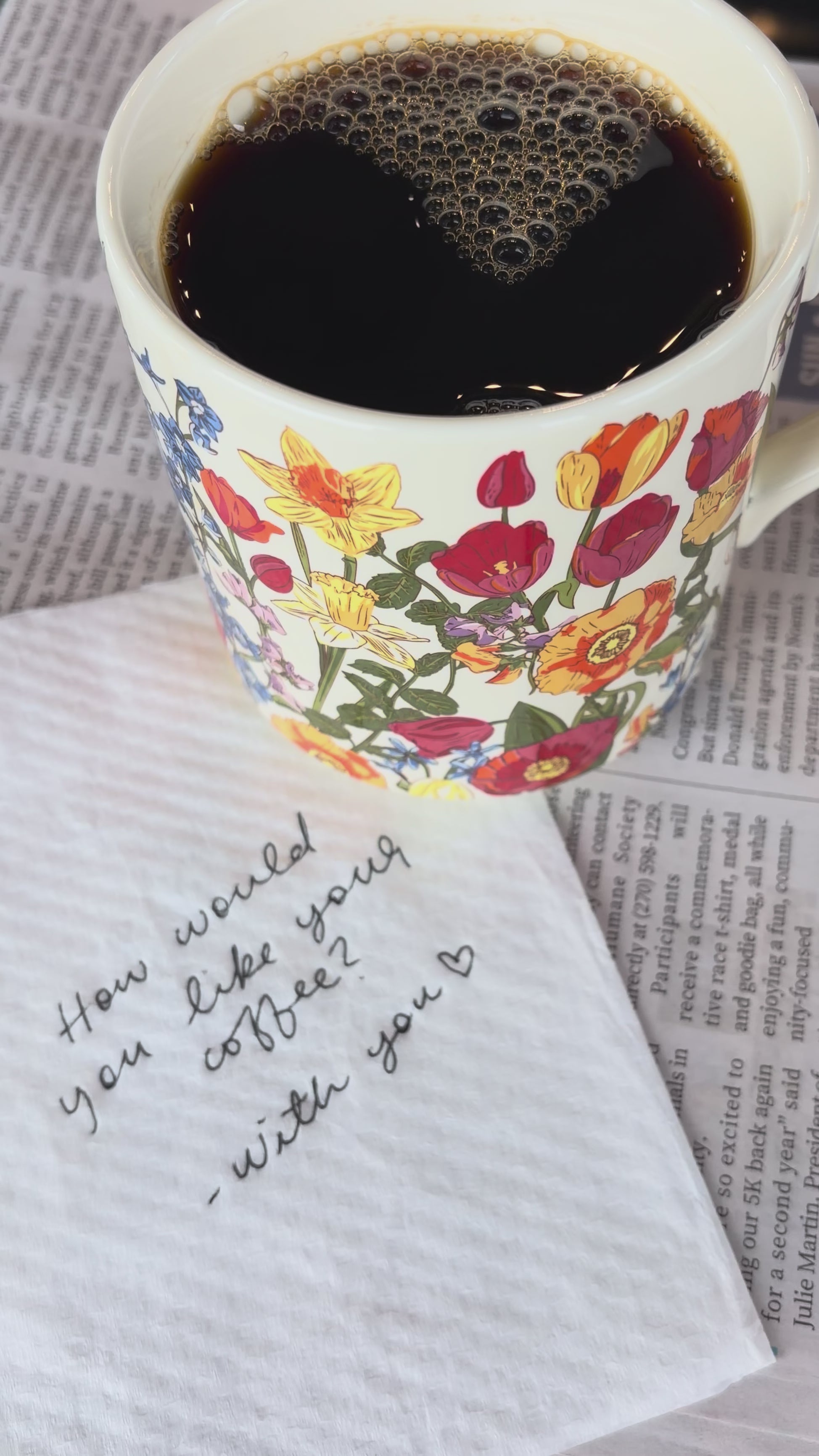 model drinking coffee out of colorful floral mug